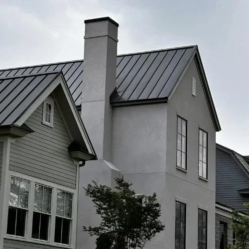 A grey color house with metal roof