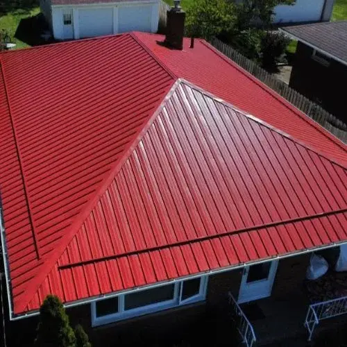 A house with red ribbed roof panels