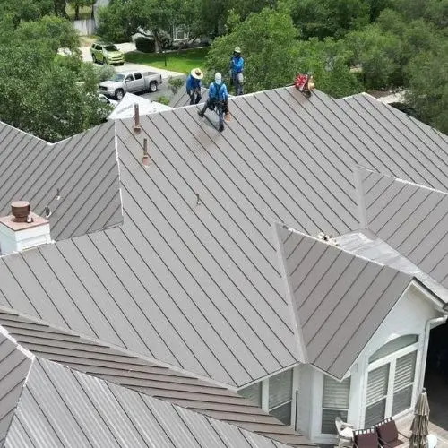 3 professionals on top of a roof